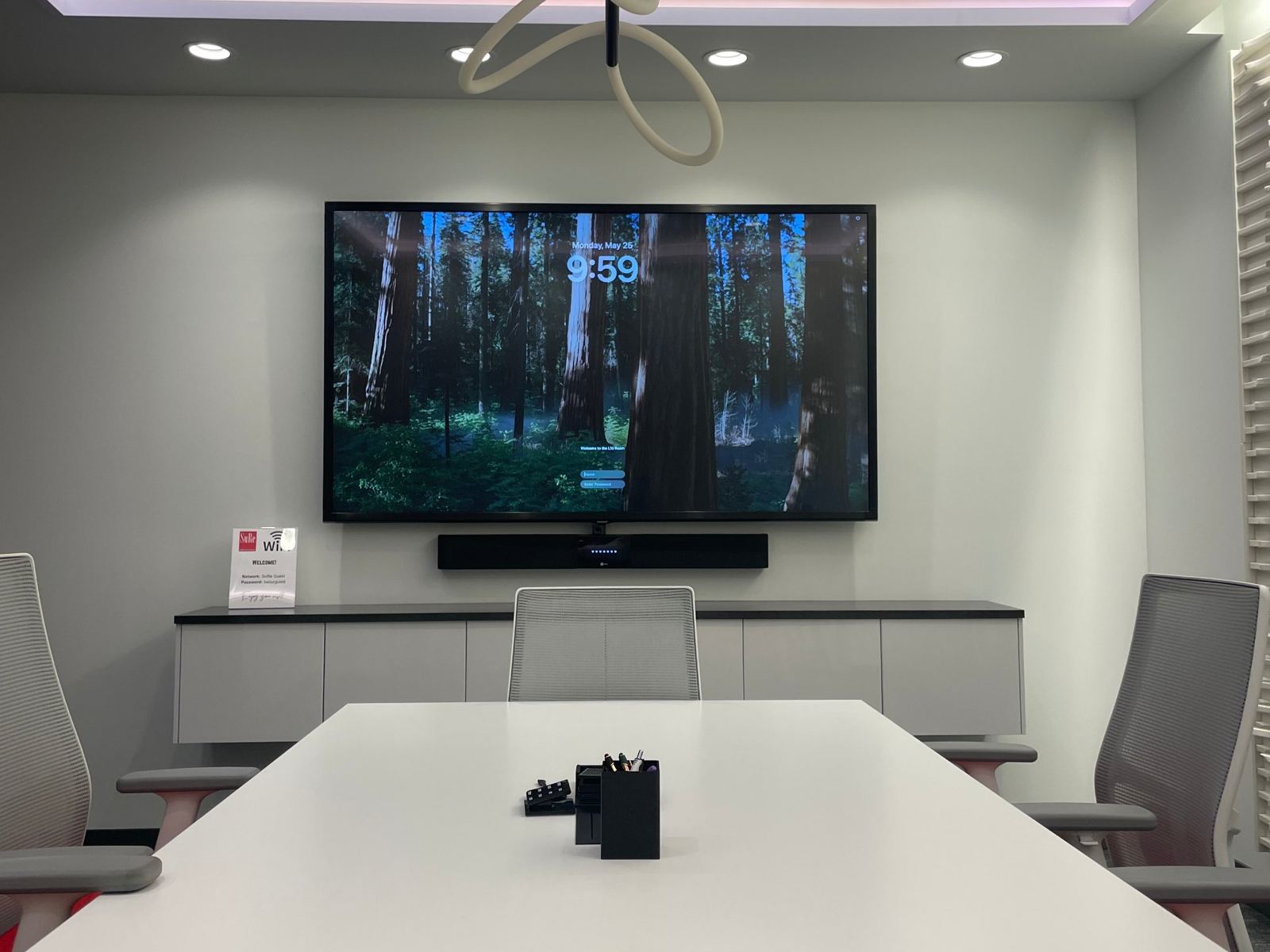 Saskatoon Experience Center meeting room with wall-mounted display and accent lighting
