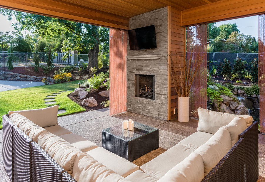 Exterior of a home with lounge, outdoor screen and fireplace